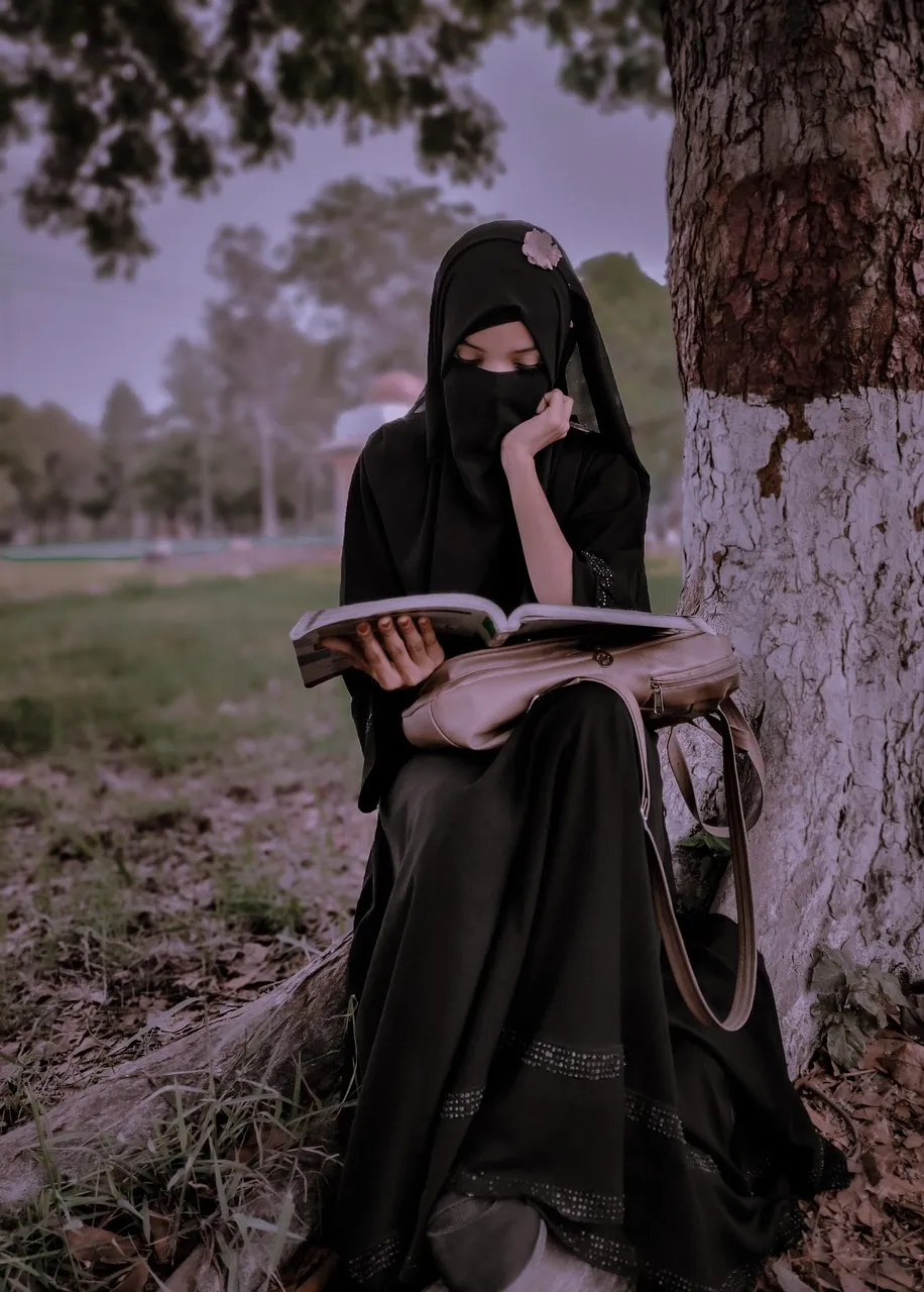 Young woman reading a book at beach